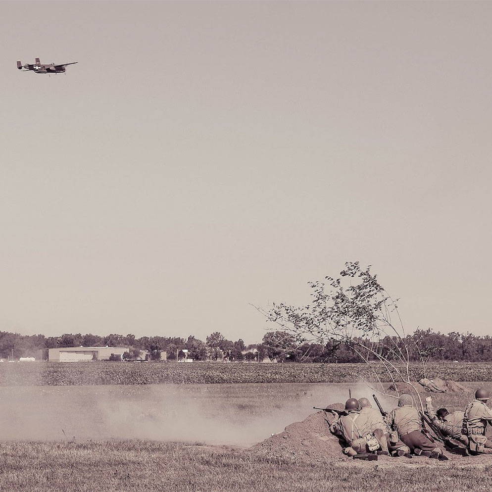 WW2 photo of airplane firing on troops